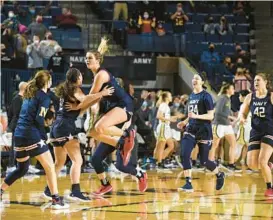  ?? PAUL W. GILLESPIE/BALTIMORE SUN MEDIA ?? Navy celebrates a win at the buzzer over Army on Jan. 22. This season’s Midshipmen are undergoing a youth movement with a lot of reliance on the incoming freshman class.