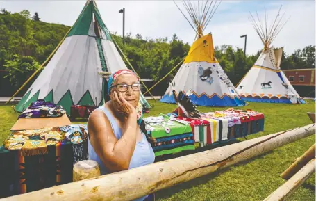  ?? AZIN GHAFFARI ?? Annie Wesley has an exhibition of traditiona­l Indigenous outfits she has made for her children outside her teepee at the Calgary Stampede's Elbow River Camp on Sunday. In the new children's book S is for Stampede, “E”is for Elbow River Camp.