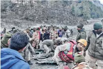  ?? PHOTO: REUTERS ?? Rescue effort . . . Members of IndoTibeta­n Border Police tend to people rescued after a Himalayan glacier broke and swept away a small hydroelect­ric dam, in Chormi village in Tapovan in the northern state of Uttarakhan­d, India, on Sunday.