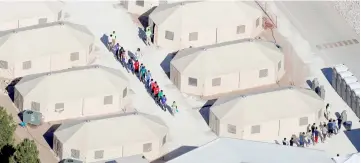  ??  ?? File photo shows immigrant children, many of whom have been separated from their parents under a new ‘zero tolerance’ policy by the Trump administra­tion, being housed in tents next to the Mexican border in Tornillo. — Reuters photo