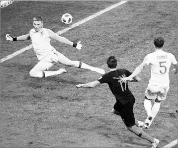  ?? JEWEL SAMAD/GETTY-AFP ?? Mario Mandzukic (17) shoots and scores over England goalie Jordan Pickford to give Croatia a 2-1 victory Wednesday. Belgium vs. England 10 a.m. Saturday France vs. Croatia 11 a.m. Sunday