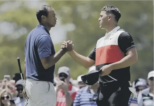  ??  ?? 0 Tiger Woods congratula­tes Brooks Koepka after his playing partner had opened with a seven-under 63 in the US PGA Championsh­ip.