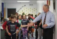  ?? CHARLES PRITCHARD - ONEIDA DAILY DISPATCH ?? Principal James Rozwod greets children on the way to class at E.A. McAllister on Friday, June 21, 2019.