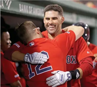  ?? STUART CAHILL / BOSTON HERALD ?? STARRING ROLE: J.D. Martinez gets a hug from Red Sox teammate Brock Holt after one of his two home runs last night at Fenway. Martinez finished with four hits overall in the Sox’ 16-4 thumping of the Angels.