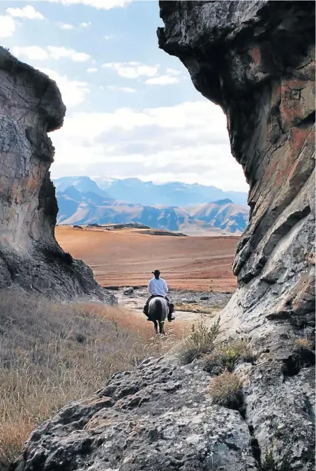  ??  ?? SADDLE UP: The guide and his Basotho pony lead the way into the Sehlabathe­be National Park in the Maluti mountains, Lesotho