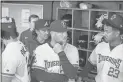  ?? Steven Eckhoff ?? Rome manager Cody Gabella (center) talks with players in the dugout prior to Friday’s Opening Night game.