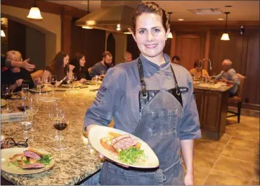  ?? STEVE MacNAULL/The Okanagan Weekend ?? Chef Jenna Pillon shows off the duck breast course at the latest cooking class at Hester Creek Winery in Oliver, which is held around the massive granite island in the winery’s demonstrat­ion kitchen.