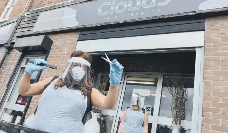  ??  ?? Cloud 9 Hair & Beauty owner Debra Ann Adamson, left, has planned a midnight appointmen­t to mark their reopening, with staff member Caitlin Trotter.