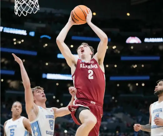  ?? AP ?? Alabama forward Grant Nelson shoots past North Carolina guard Paxson Wojcik during the second half of their NCAA Sweet 16 game Thursday night in Los Angeles.