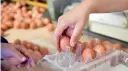  ??  ?? Employees handle eggs at an egg farm in Gaesti, Romania. AFP / Daniel Mihailescu