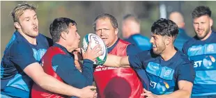  ?? Pictures: SNS. ?? Doddie Weir, right, launches his autobiogra­phy at BT Murryfield last week; Adam Hastings and Lee Jones, left, in Scotland training at the Oriam yesterday.