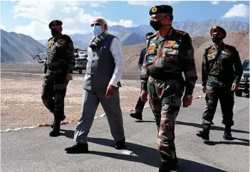  ??  ?? (Top) “The enemies have seen your fire and fury” - Prime Minister Narendra Modi addressing soldiers at Nimu in Ladakh. The Leh based 14 Corps is also known as the Fire and Fury Corps; (Above) Prime Minister Narendra Modi with Chief of Defence Staff General Bipin Rawat (left) & Army Chief General M.M. Naravane (front right) during his visit in Ladakh.