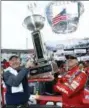  ?? WADE PAYNE — THE ASSOCIATED PRESS ?? Food City president and CEO, Steve Smith, left, holds the trophy with race winner Kyle Busch after a NASCAR Cup Series auto race, Monday in Bristol, Tenn.