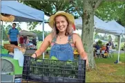  ?? / Olivia Mead, Berry College. ?? Berry College student Dara Sparks refills Seasons Harvest’s bin of green peppers during a farmers market at the Clara Bowl on July 15, 2017.