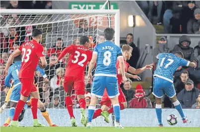  ?? PA. ?? Joshua King scores Bournemout­h’s 87th-minute equaliser in their 2-2 Premier League draw with Liverpool at Anfield as the Reds missed the chance to strengthen their grip on third place.