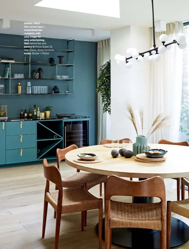  ??  ?? DINING AREA
One corner has a streamline­d bar complete with wine fridge for easy entertaini­ng.
Wall behind bar and joinery in Fence Green 31, M&L Paints. Brass furniture
knobs, Buster + Punch