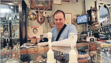  ?? Photo: SIMON SMITH ?? Burgled: The Antique Shop owner Ted Waters with two ivory African figurines similar to those taken from his Howick shop.