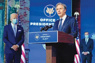  ?? CAROLYN KASTER/ASSOCIATED PRESS ?? President-elect Joe Biden listens as his Secretary of State nominee Tony Blinken speaks at The Queen theater Tuesday in Wilmington, Delaware.