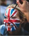  ??  ?? A woman is painted with a British flag on her face, as they wait at The Long Walk to watch the carriage procession after the wedding of Britain’s Prince Harry and Meghan Markle at St. George’s Chapel Saturday.