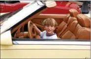  ??  ?? Jason, 7, sits behind the wheel of a 1989 Chrysler Maserati during Boyertown’s Cruise Night.