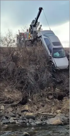  ?? COURTESY OF BOB GRAY ?? A vehicle that crashed into the Big Thompson River on Wednesday is dragged out of the gulch after the driver was rescued and taken to Medical Center of the Rockies.