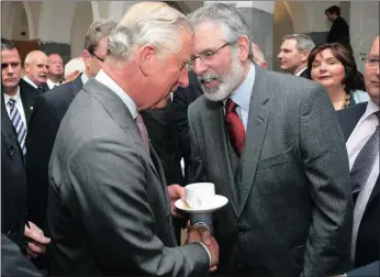  ?? PICTURE: AP ?? Britain’s Prince Charles, left, shakes hands with Sinn Fein president Gerry Adams at the National University of Ireland in Galway yesterday. Charles has begun an official visit to Ireland featuring two milestones of peacemakin­g: his first meeting with...