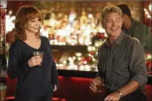  ?? LIFETIME ?? Reba McEntire and John Schneider play a couple and singing duo in “Reba McEntire’s Christmas in Tune.”