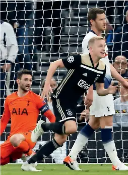  ?? — AFP ?? Ajax midfielder donny van de Beek celebrates his goal as tottenham’s goalkeeper hugo lloris (left) reacts during the Champions league game.