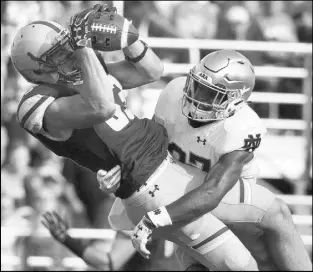  ?? Michael Dwyer The Associated Press ?? Boston College wide receiver Charlie Callinan catches a touchdown pass against Notre Dame cornerback Julian Love in the second quarter of the Fighting Irish’s 49-20 win Saturday.