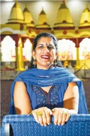  ?? STAFF PHOTO BY TIM BARBER ?? Sheila Boyington is in traditiona­l Indian dress inside the Hindu Temple at Gujarati Samaj Of East Tennessee.