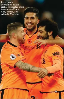  ??  ?? Liverpool's Mohamed Salah, right, celebrates with teammates Emre Can, center, and Alberto Moreno