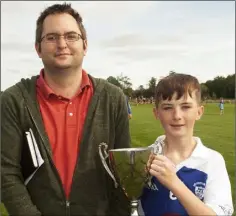  ??  ?? Dean Goodison of the sponsors with Ballyhogue captain Keith Roche.