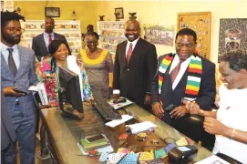  ??  ?? A cashier prepares to swipe after the First Family bought artefacts from the National Art Gallery in Bulawayo during a tour yesterday. Looking on are the First Lady (second from left), the regional manager of the gallery Mr Butholezwe Nyathi (left), Director National Art Gallery of Zimbabwe Doreen Sibanda (third from left) and Deputy Minister of Youth, Sports, Arts and Recreation Tino Machakaire. (Picture by Eliah Saushoma)