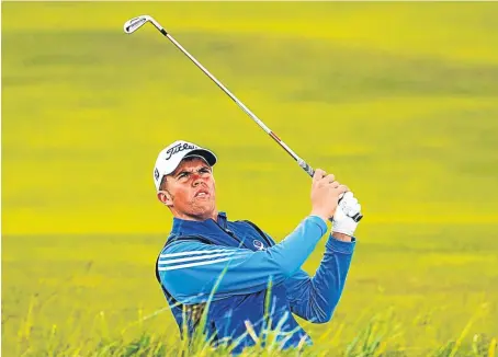  ?? Picture: SNS Group. ?? Greig Marchbank chips onto the second fairway from the bunker.