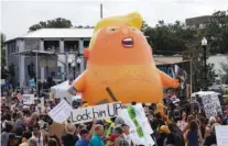  ?? AP PHOTO/CHRIS O’MEARA ?? An inflatable Baby Trump balloon towers over protesters during a rally in Orlando, Fla., in 2019.