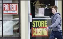 ?? (AP PHOTO/TONY DEJAK) ?? A man walks past a closed business, Wednesday, April 29, 2020, in Chagrin Falls, Ohio.