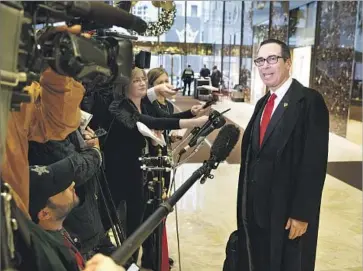  ?? Evan Vucci Associated Press ?? STEVE MNUCHIN, President-elect Donald Trump’s nominee for Treasury secretary, talks with reporters Wednesday in the lobby of Trump Tower in New York. At one time he led Pasadena lender OneWest Bank.