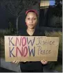  ?? STACEY PLAISANCE — THE ASSOCIATED PRESS ?? Janae Jamison holds a sign as she poses for a portrait at a rally for George Floyd June 5in the French Quarter of New Orleans.