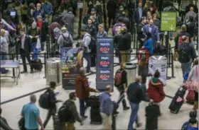  ?? JOHN SPINK - THE ASSOCIATED PRESS ?? Security lines at Hartsfield-Jackson Internatio­nal Airport in Atlanta stretch more than an hour long amid the partial federal shutdown, causing some travelers to miss flights, Monday morning, Jan. 14, 2019.