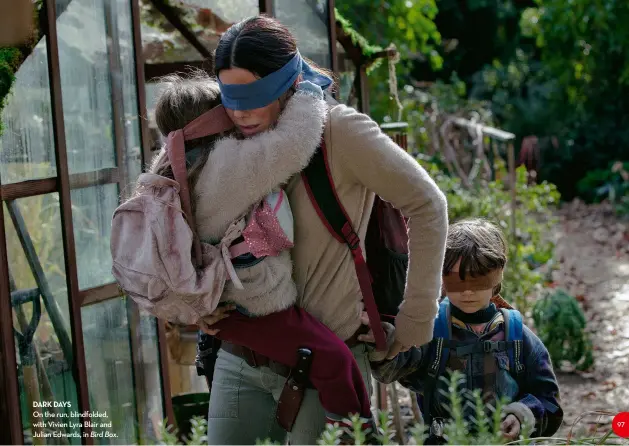  ??  ?? daRK daYSOn the run, blindfolde­d, with vivien Lyra Blair and Julian edwards, in Bird Box.