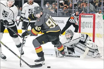  ?? Photograph­s by John Locher Associated Press ?? VEGAS LEFT WING Tomas Tatar battles in front of Kings goaltender Jonathan Quick during the second period. The Golden Knights got a first-period goal from former Duck Shea Theodore and made it stand up in the first playoff game in Las Vegas.
