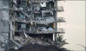  ?? (AP/Lynne Sladky) ?? A giant tarp covers a section of rubble where search and rescue personnel had been working at the Champlain Towers South condo building, as demolition experts were preparing to bring down the precarious still-standing portion on July 4, 2021, in Surfside, Fla.