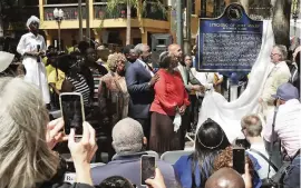  ?? JOHN RAOUX AP, file 2019 ?? Descendant­s of July Perry, along with elected officials and residents, attend a ceremony unveiling a historical marker in Orlando. Perry was lynched by a white mob after helping a friend who tried to vote. After Perry was lynched, the mob laid siege to the Black section of Ocoee. Some historians estimate the death toll could have been as high as 60.