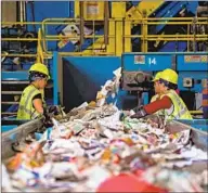  ?? Saul Loeb AFP/Getty Images ?? RECYCLED materials are sorted in Elkridge, Md. When machines are used to sort, plastic mailers can get by them and wind up in bales of paper, contaminat­ing bundles.