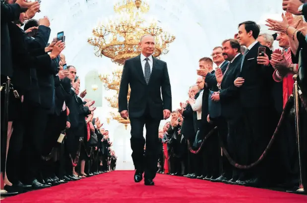  ?? ALEXANDER ZEMLIANICH­ENKO / AFP / GETTY IMAGES ?? Russian president-elect Vladimir Putin walks to his meticulous­ly choreograp­hed inaugurati­on ceremony at the Kremlin in Moscow.