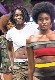  ??  ?? Jeneil Williams (centre) joins models for final walk of her premiere collection, Rogue Creations, during the final night of Caribbean Fashion Week 2017