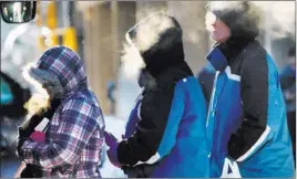  ?? BOB KING/ THE ASSOCIATED PRESS ?? Passengers board a bus Monday in Duluth, Minn. Tonight’s forecast is minus 20 degrees.