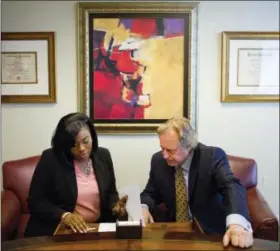  ?? DAVID GOLDMAN — THE ASSOCIATED PRESS ?? Sharonda Fields, left, who said she was abused while working at a Georgia restaurant last year, talks with her attorney Brad Dozier in his office in Atlanta, Monday.