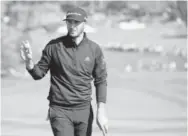  ?? Eric Risberg, The Associated Press ?? Dustin Johnson acknowledg­es the crowd after making a birdie Saturday.