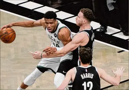  ?? Frank Franklin II / Associated Press ?? Brooklyn Nets’ Blake Griffin, top right, defends against Milwaukee Bucks’ Giannis Antetokoun­mpo (34) during the first half of Game 7 of a second-round playoff series Saturday in New York.